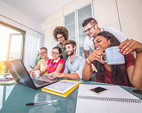 six diverse people looking at a computer with joy in their face